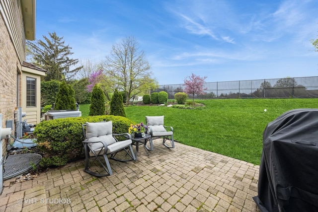 view of patio featuring area for grilling and fence