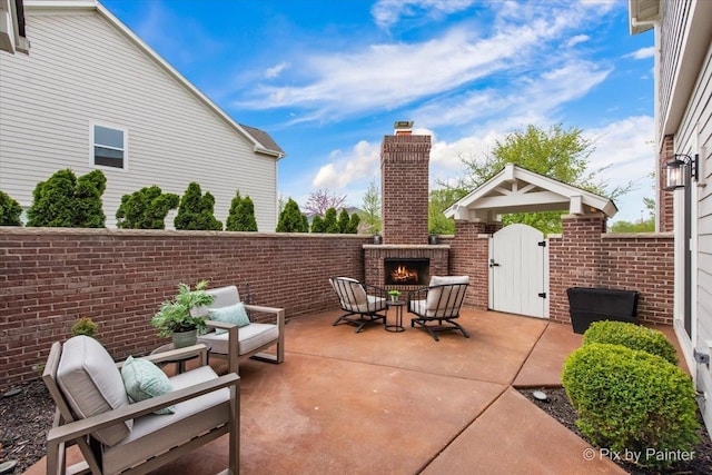 view of patio / terrace featuring an outdoor brick fireplace