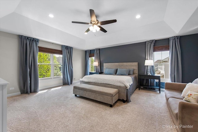 carpeted bedroom with baseboards, a ceiling fan, a tray ceiling, and recessed lighting