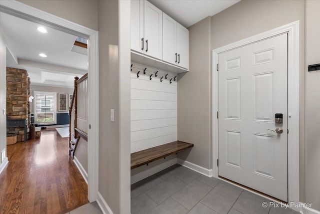 mudroom featuring baseboards, rail lighting, tile patterned flooring, and recessed lighting
