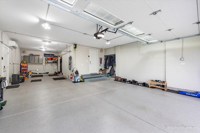 garage with a garage door opener and a wall mounted air conditioner