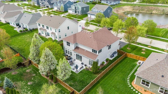drone / aerial view featuring a water view and a residential view