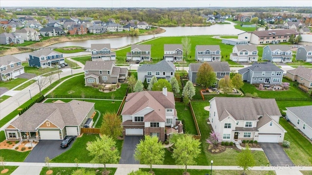birds eye view of property with a water view and a residential view