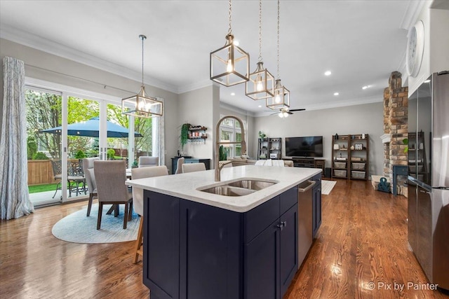kitchen with open floor plan, dark wood finished floors, decorative light fixtures, and stainless steel appliances