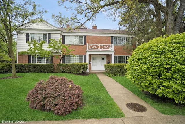 444 Winnetka Ave, Winnetka, IL 60093 - view of front of property with brick siding, a chimney, and a front lawn