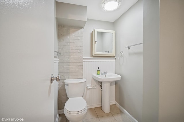 444 Winnetka Ave, Winnetka, IL 60093 - half bathroom featuring toilet, tile patterned flooring, wainscoting, and baseboards