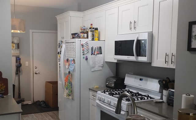 1373 Grayshire Ct, Elgin, IL 60120 - kitchen featuring white cabinetry, wood finished floors, hanging light fixtures, and white appliances