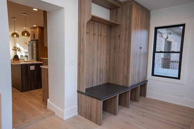 mudroom with recessed lighting, baseboards, and light wood-type flooring
