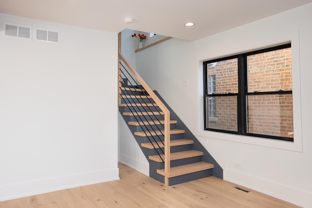 stairs featuring baseboards, recessed lighting, wood finished floors, and visible vents