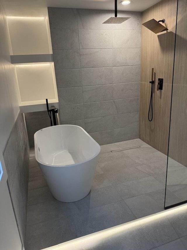 bathroom featuring tile walls and walk in shower