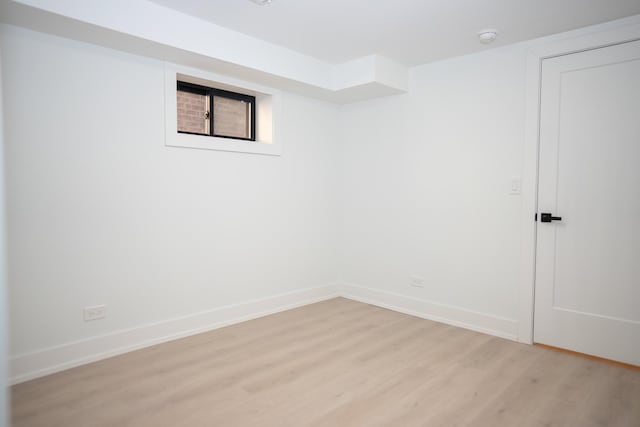 unfurnished room with baseboards and light wood finished floors