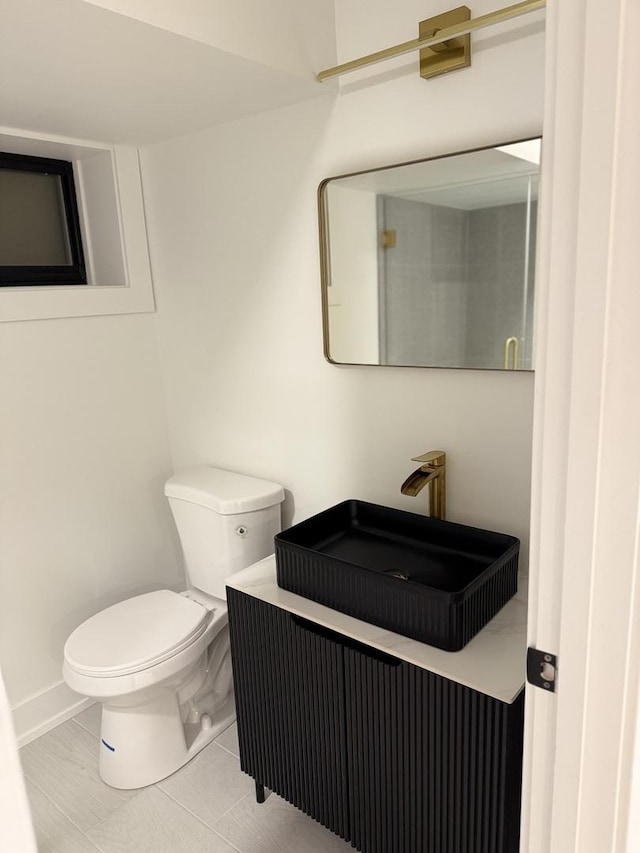 half bath with toilet and baseboards