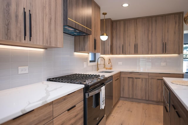 kitchen with range with gas stovetop, a sink, modern cabinets, and backsplash