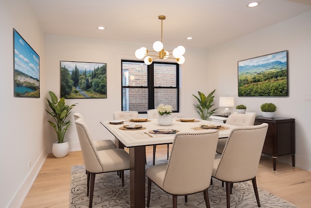 dining space with recessed lighting, baseboards, light wood-type flooring, and a chandelier