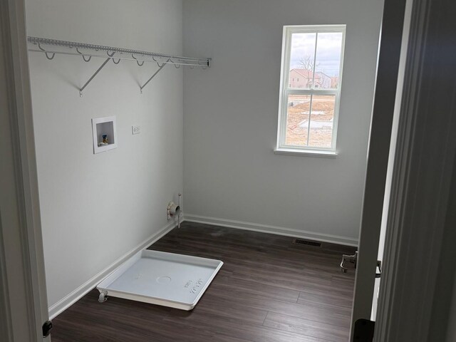 laundry room featuring wood finished floors, laundry area, washer hookup, baseboards, and visible vents