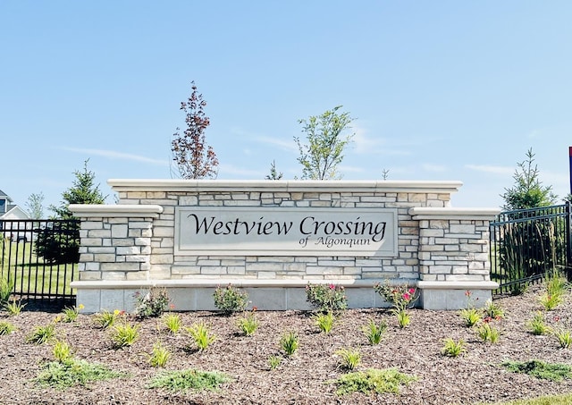 community / neighborhood sign featuring fence