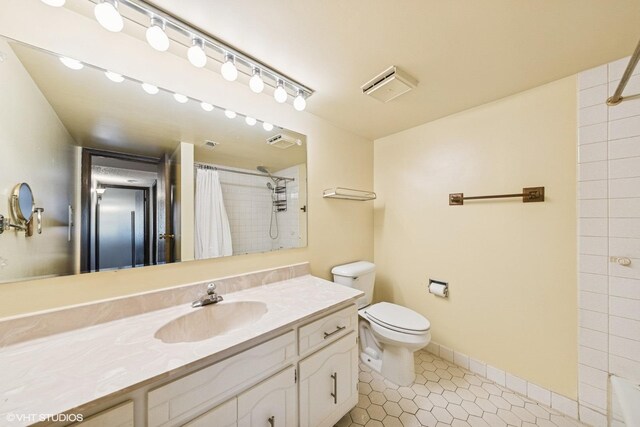 bathroom with vanity, visible vents, toilet, a shower with shower curtain, and tile patterned floors
