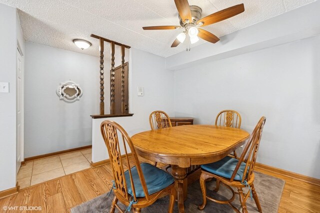 dining area with baseboards, a textured ceiling, light wood-style flooring, and ceiling fan