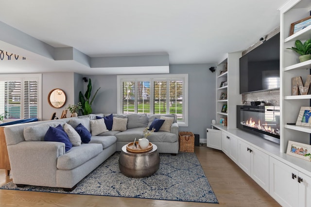 1137 Griffith Rd, Lake Forest, IL 60045 - living room featuring a glass covered fireplace, plenty of natural light, and wood finished floors