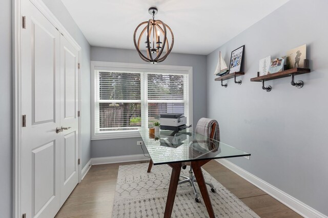 1137 Griffith Rd, Lake Forest, IL 60045 - dining space with a desk, baseboards, wood finished floors, and a chandelier