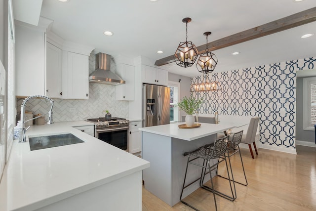 1137 Griffith Rd, Lake Forest, IL 60045 - kitchen featuring stainless steel appliances, wall chimney range hood, a sink, white cabinets, and light countertops
