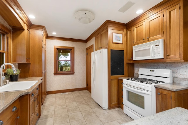 13459 N Tower Rd N, Lee, IL 60530 - kitchen featuring white appliances, brown cabinets, a sink, crown molding, and baseboards