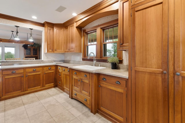 13459 N Tower Rd N, Lee, IL 60530 - kitchen with a sink, brown cabinetry, decorative backsplash, light tile patterned floors, and crown molding