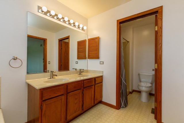 bathroom featuring a sink, tile patterned floors, toilet, and double vanity