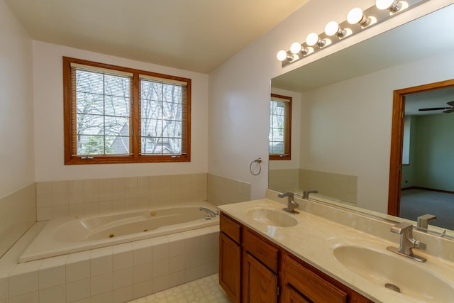 bathroom featuring plenty of natural light, a sink, and a jetted tub