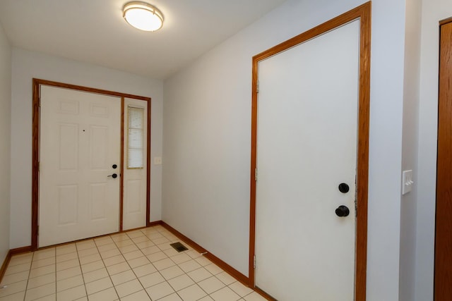 foyer entrance with baseboards and visible vents