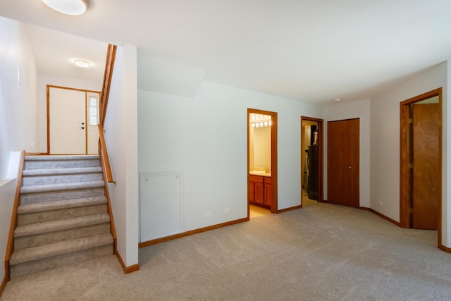 staircase with baseboards and carpet
