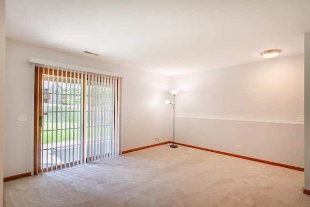 unfurnished room with visible vents, carpet flooring, and baseboards
