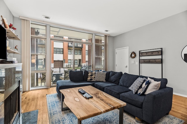 324 N Jefferson St Unit 101, Chicago, IL 60661 - living room with a wall of windows, visible vents, and light wood-type flooring