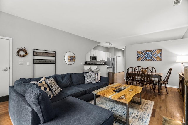324 N Jefferson St Unit 101, Chicago, IL 60661 - living area with visible vents and dark wood finished floors