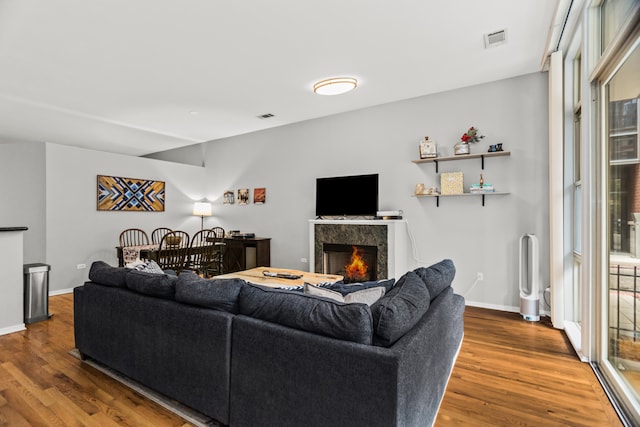 324 N Jefferson St Unit 101, Chicago, IL 60661 - living room featuring visible vents, wood finished floors, and a fireplace