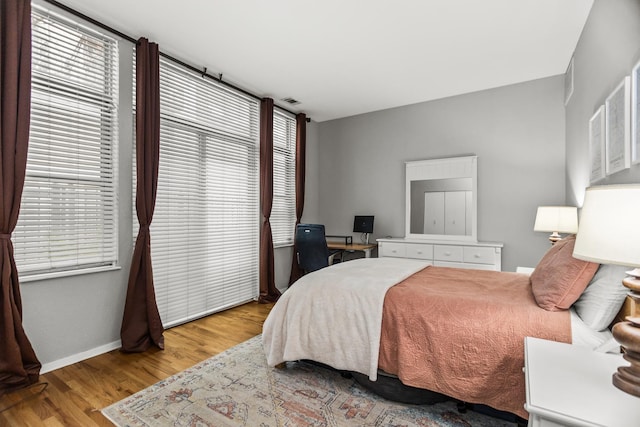 324 N Jefferson St Unit 101, Chicago, IL 60661 - bedroom featuring baseboards and wood finished floors