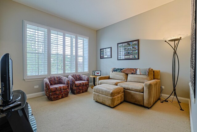 carpeted living room with baseboards
