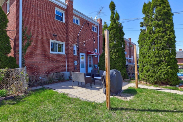 479 Oak St, Des Plaines, IL 60016 - rear view of house with fence, a patio area, a yard, and brick siding