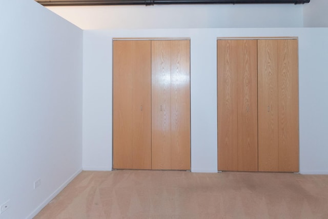 1250 W Van Buren St Unit 203, Chicago, IL 60607 - unfurnished bedroom featuring carpet flooring, multiple closets, and baseboards