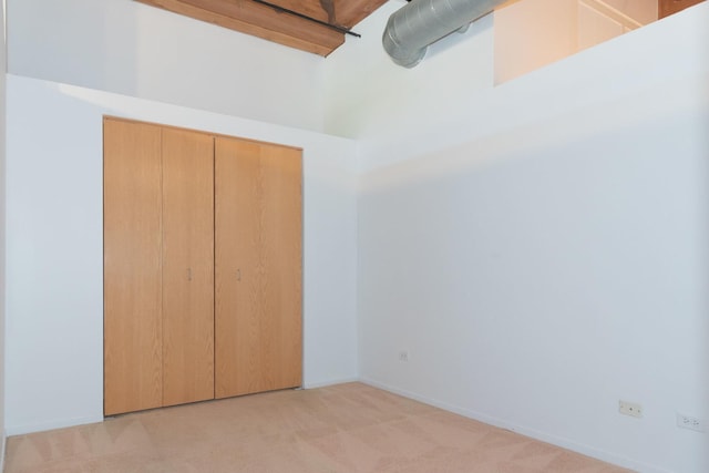 1250 W Van Buren St Unit 203, Chicago, IL 60607 - unfurnished bedroom featuring light carpet, a closet, and baseboards