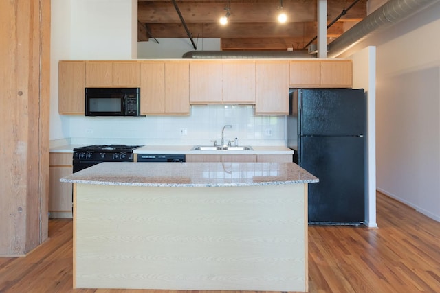 1250 W Van Buren St Unit 203, Chicago, IL 60607 - kitchen with black appliances, a sink, light brown cabinetry, light wood-type flooring, and a center island