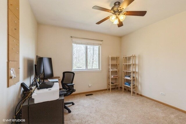 office area featuring baseboards, carpet flooring, ceiling fan, and visible vents