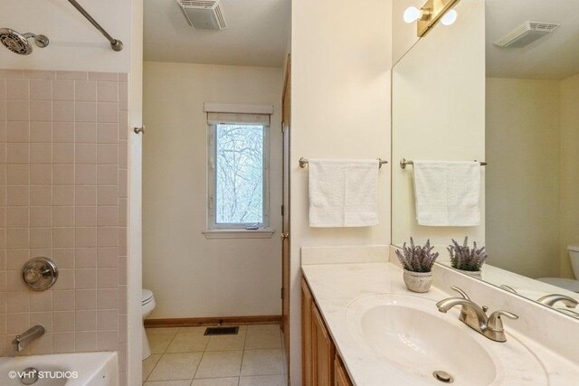 full bathroom featuring toilet, visible vents, and tile patterned flooring