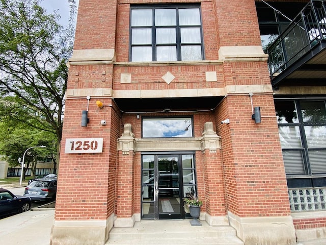 1250 W Van Buren St Unit 202, Chicago, IL 60607 - view of exterior entry featuring brick siding