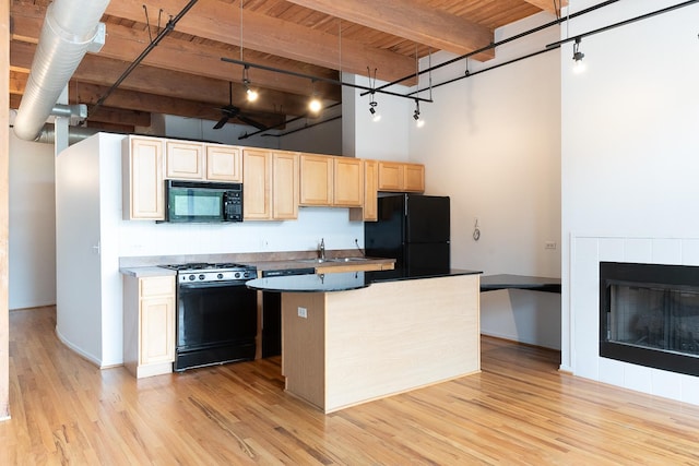 1250 W Van Buren St Unit 202, Chicago, IL 60607 - kitchen featuring black appliances, wooden ceiling with exposed beams, a towering ceiling, light wood-style flooring, and light brown cabinets
