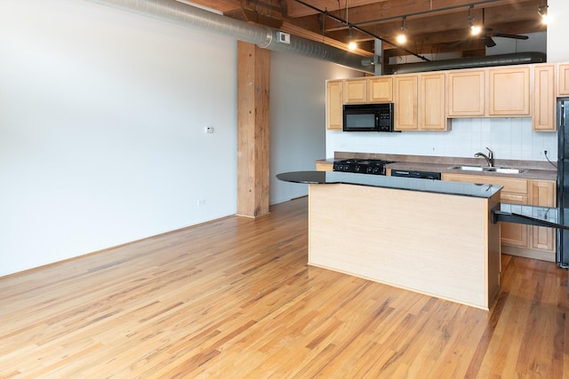 1250 W Van Buren St Unit 202, Chicago, IL 60607 - kitchen featuring black appliances, light brown cabinets, track lighting, light wood finished floors, and a sink