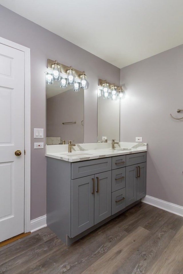534 Philip Dr, Bartlett, IL 60103 - bathroom with wood finished floors, baseboards, and double vanity