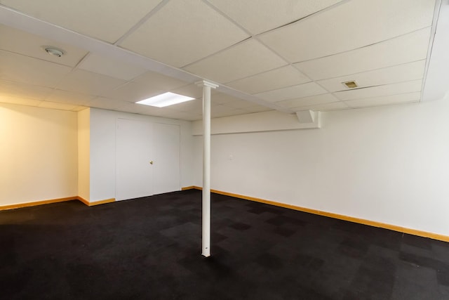 534 Philip Dr, Bartlett, IL 60103 - finished below grade area with baseboards, a paneled ceiling, and dark carpet
