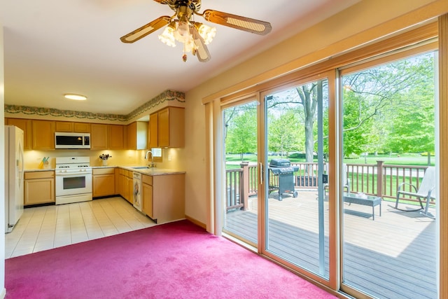 534 Philip Dr, Bartlett, IL 60103 - kitchen featuring white appliances, a sink, light countertops, light colored carpet, and ceiling fan