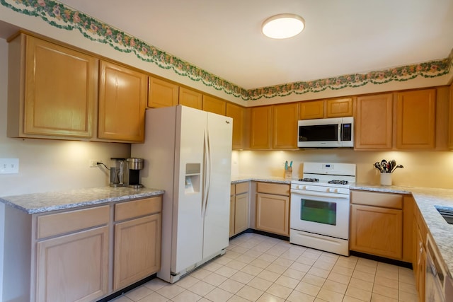534 Philip Dr, Bartlett, IL 60103 - kitchen with white appliances, light tile patterned flooring, and light stone counters